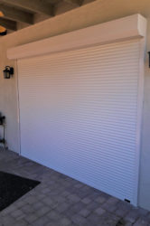 Rolling shutters protecting glass double doors of a Tucson, Arizona home