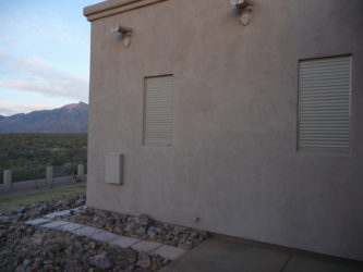 Exterior rolling shutters protecting windows of a home